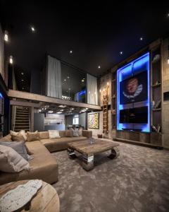 a large living room with a couch and a tv at The Bells - Luxury Serviced Apartments in Leeds