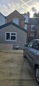 a car parked in front of a house at Town Centre Studio with Ensuite in Aylesbury