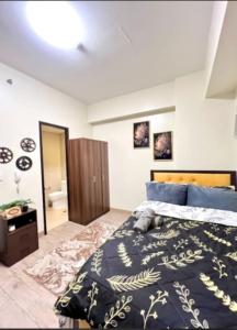 a bedroom with a bed with a blue comforter at 3ff Megaworld, One Regis in Bacolod