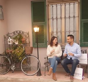 a man and woman sitting on a bench next to a bike at La corte del Gavi in Bosio