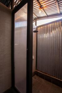 a hallway with a glass door in a room at Alun Hostel in San Felipe