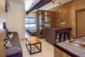 a living room with a couch and a bed at Rau Departamentos in Guadalajara
