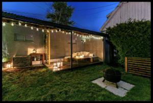 a backyard with lights and a couch in the grass at Hanaborg Appartments in Lorenskog