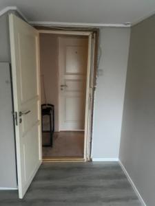an empty room with a door and a hallway at Hanaborg Appartments in Lorenskog