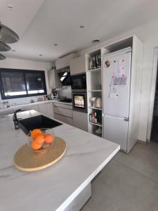 a kitchen with a counter with a bowl of oranges on it at Jolie villa in Piolenc
