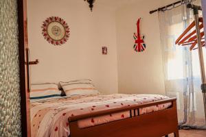 a bedroom with a bed and a clock on the wall at La corte del Gavi in Bosio