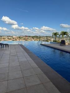 a swimming pool with a view of a city at Flat Duo JK. Lindo e completo in Sao Jose do Rio Preto