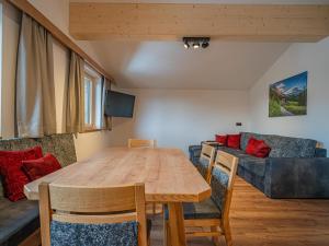 a dining room with a table and a couch at Glückauf in Krimml