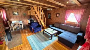 a living room with a couch and a staircase at Apartment Mateja in Mokra Gora