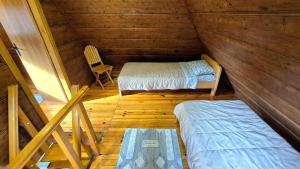 a room with two beds and a chair in a cabin at Apartment Mateja in Mokra Gora +66 photos