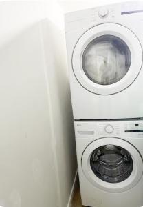 a white washer and dryer in a room at DeHaven in Edmonton