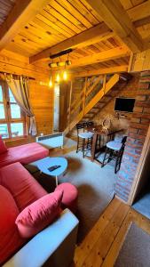 a living room with a red couch and a table at Apartment Mateja in Mokra Gora