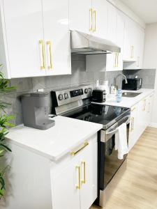 a kitchen with white cabinets and a stove top oven at DeHaven in Edmonton