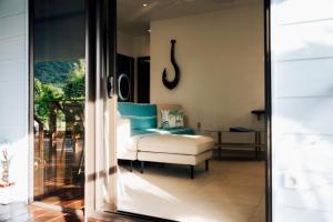 a living room with a couch and a chair at Nanua Lodge 2 blue in Bora Bora