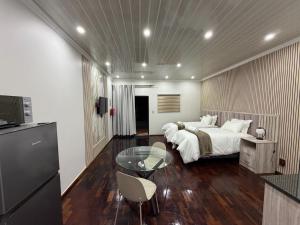 a bedroom with a bed and a glass table at Mehraz Guesthouse in Piet Retief