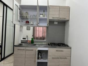 a small kitchen with a sink and a stove at San Luis Apartamento 302 Cúcuta in Cúcuta +8 photos