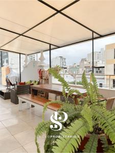 a patio with a table and a large umbrella at Casa Águila y Cóndor Miraflores in Lima