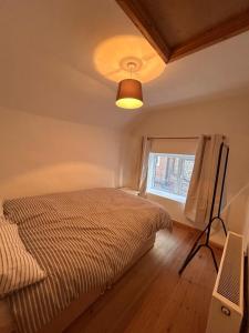 a bedroom with a bed and a window at Mundesley Cosy cottage in Mundesley