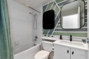 a bathroom with a sink and a toilet and a mirror at Sub-Penthouse view condo in Downtown in Vancouver +15 photos