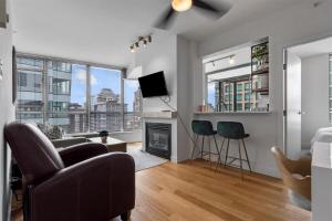 a living room with a couch and a fireplace at Sub-Penthouse view condo in Downtown in Vancouver