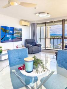 a living room with blue chairs and a table at The Enderley Escape in Gold Coast