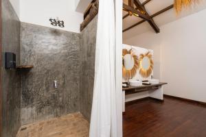 a bathroom with a shower with two mirrors on the wall at Kampung Kamboja in Phum Pobos +44 photos