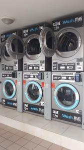 a row of washing machines in a store at cœur d hibiscus in Sainte-Luce
