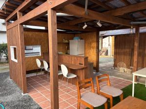 an outdoor kitchen with a table and chairs at Kikuchi Mirai Base - 菊池みらいベース in Kikuchi
