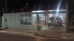 a gate in front of a building at night at mendes in Água Boa