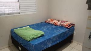 a small bed with two pillows on top of it at mendes in Água Boa
