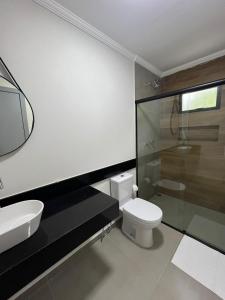 a bathroom with a toilet and a sink and a shower at Pousada Vila Palmital in Paraty +62 photos