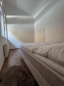a bedroom with a bed and a mirror on the wall at Komfortresidenz Natur in Weiz