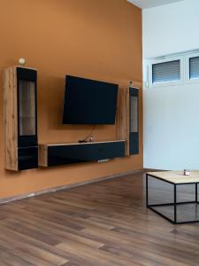 a living room with a flat screen tv on a wall at Komfortresidenz Natur in Weiz