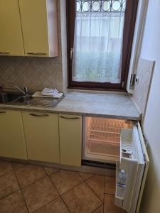 a small kitchen with a sink and a window at Rolly Home - Verona Apartment in Verona +8 photos