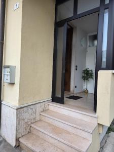 a front door of a building with a stairway at Rolly Home - Verona Apartment in Verona
