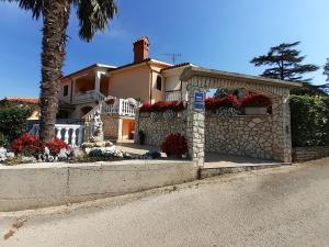a house with flowers on the side of the street at Family-friendly apartments with swimming pool Nedescina, Central Istria - Sredisnja Istra - 7455 in Nedeščina