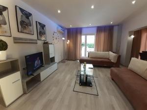 a living room with a couch and a tv at Family-friendly apartments with swimming pool Nedescina, Central Istria - Sredisnja Istra - 7455 in Nedeščina