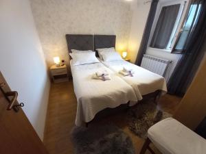 a bedroom with a bed with two towels on it at Family-friendly apartments with swimming pool Nedescina, Central Istria - Sredisnja Istra - 7455 in Nedeščina +30 photos