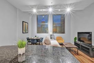 a living room with a table and a couch at Central Downtown Condo | Parking & Pool Table in Cleveland