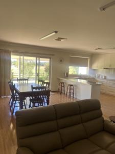 a living room with a couch and a table with chairs at 367 The Avenue in Harvey