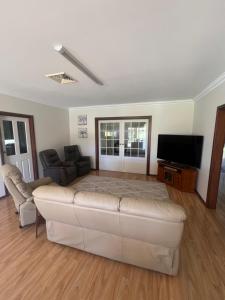 a living room with a couch and a flat screen tv at 367 The Avenue in Harvey