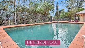 a swimming pool in a house with a fence at Villa Rose with Free Wine Tasting Included in Pokolbin