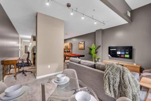 a living room with a couch and a table at Luxe Downtown Condo • Pool Table & Parking in Cleveland