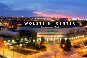 a building with a sign that reads woltten center at night at Luxe Downtown Condo • Pool Table & Parking in Cleveland