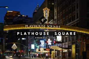 a playhouse square sign on a city street at night at Theater District Gem • Downtown Hideaway in Cleveland