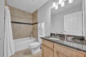 a bathroom with a sink and a toilet and a bath tub at Theater District Gem • Downtown Hideaway in Cleveland +23 photos