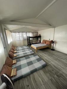 a room with two beds and a checkered floor at Gratum Beach 1 & 2 Resorts Glamping in Dapitan +74 photos