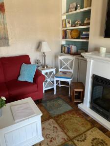 a living room with a red couch and a fireplace at Just Gotta Getaway in Port Orange