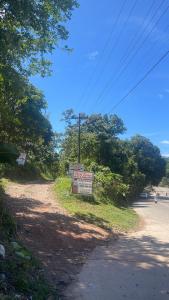 a sign on the side of a dirt road at GetAway Apartment in El Nido