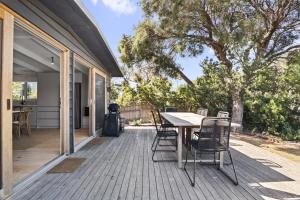 a wooden deck with a table and chairs on it at Casa Piccolo - Peninsula Hot Springs 5 mins away in Rye +12 photos